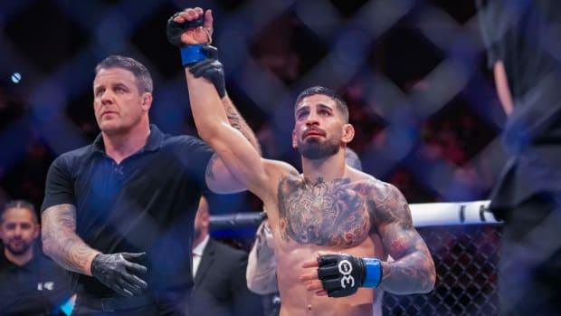 Ilia Topuria in the Octagon with his right arm raised in victory